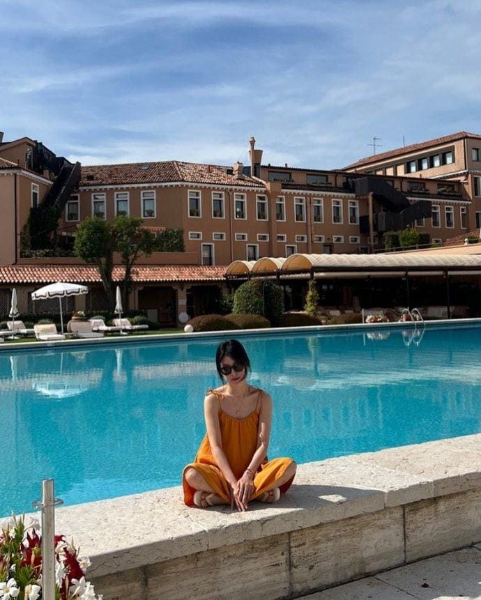 Song Hye Kyo rạng rỡ với váy hai dây màu cam đất.